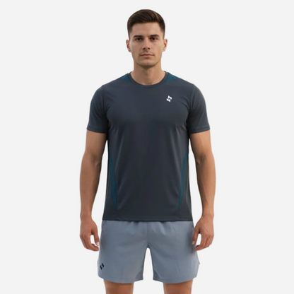 Man wearing a dark gray athletic shirt and gray shorts on a white background