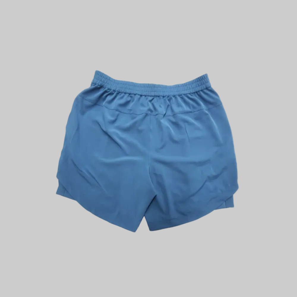 Blue athletic SOPRO shorts with an elastic waistband, shown from the back on a plain white background.