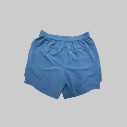 Blue athletic SOPRO shorts with an elastic waistband, shown from the back on a plain white background.