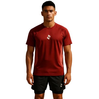 Man wearing a red athletic shirt with a logo on a brown background