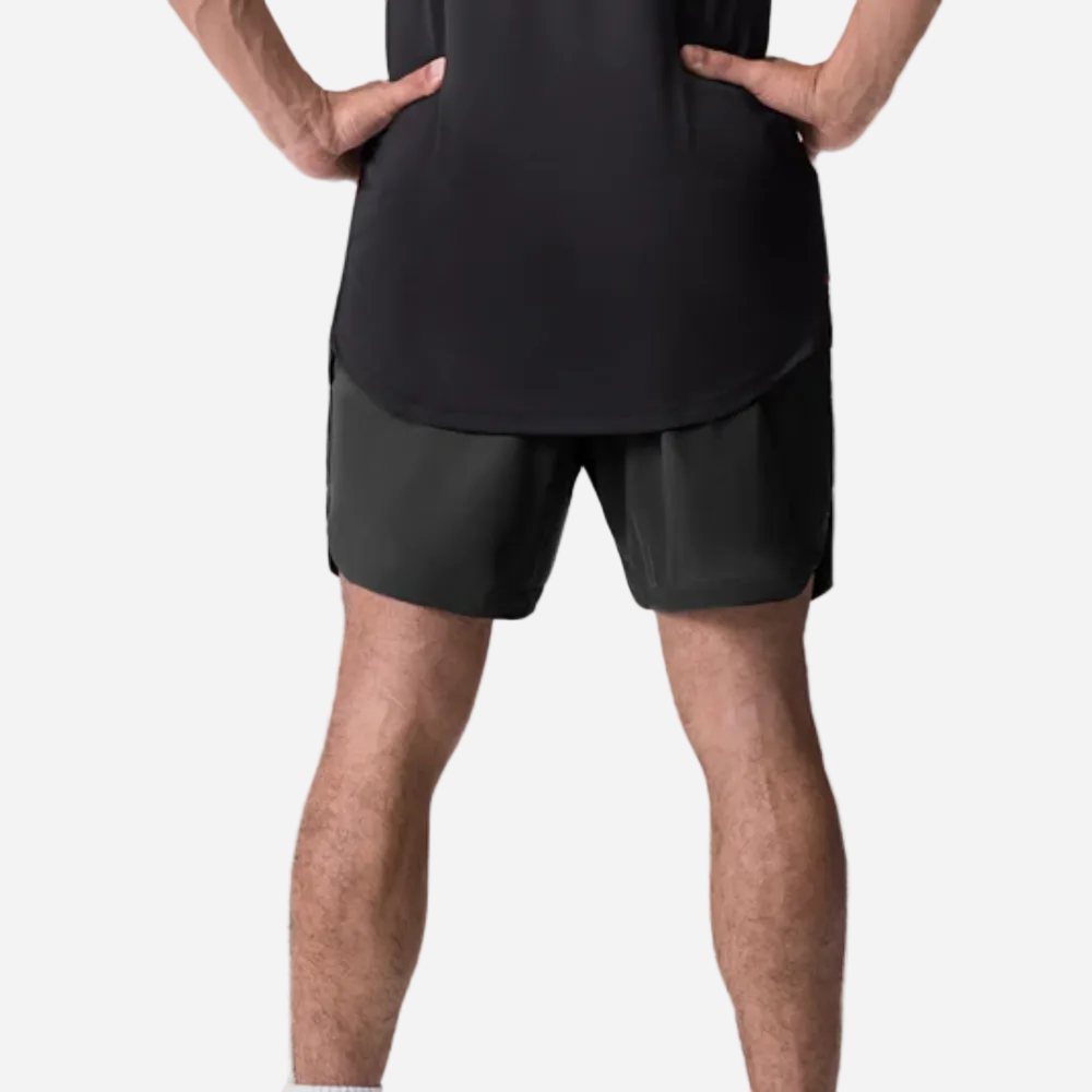 Person wearing black athletic shorts and a black shirt on a light gray background