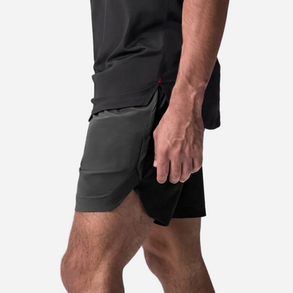 Person wearing black and black athletic sopro shorts on a light gray background