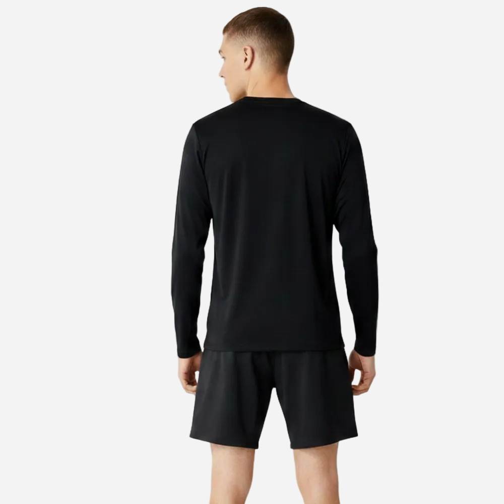 Man wearing a black long-sleeve sopro shirt and black shorts on a gray background